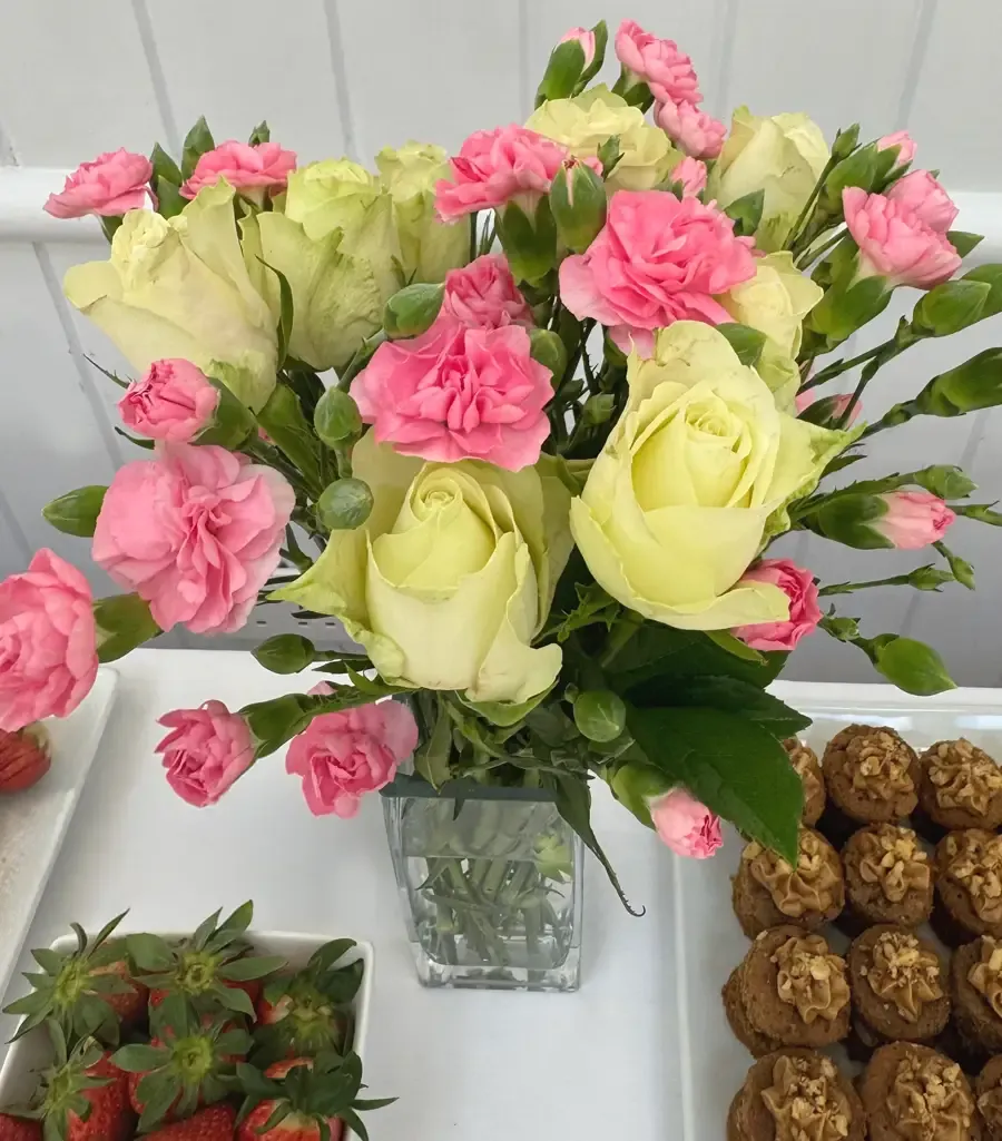 A table vase of roses