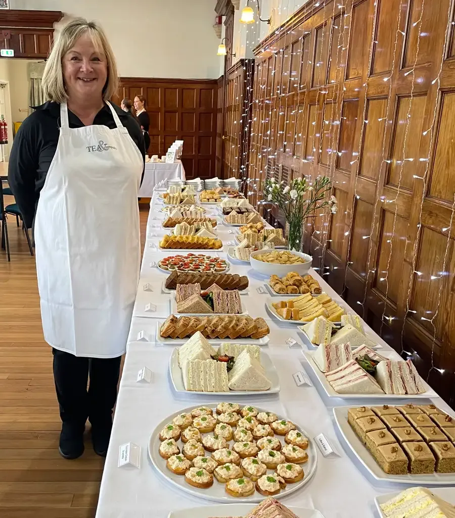 Kim Clark in front of freshly laid buffet
